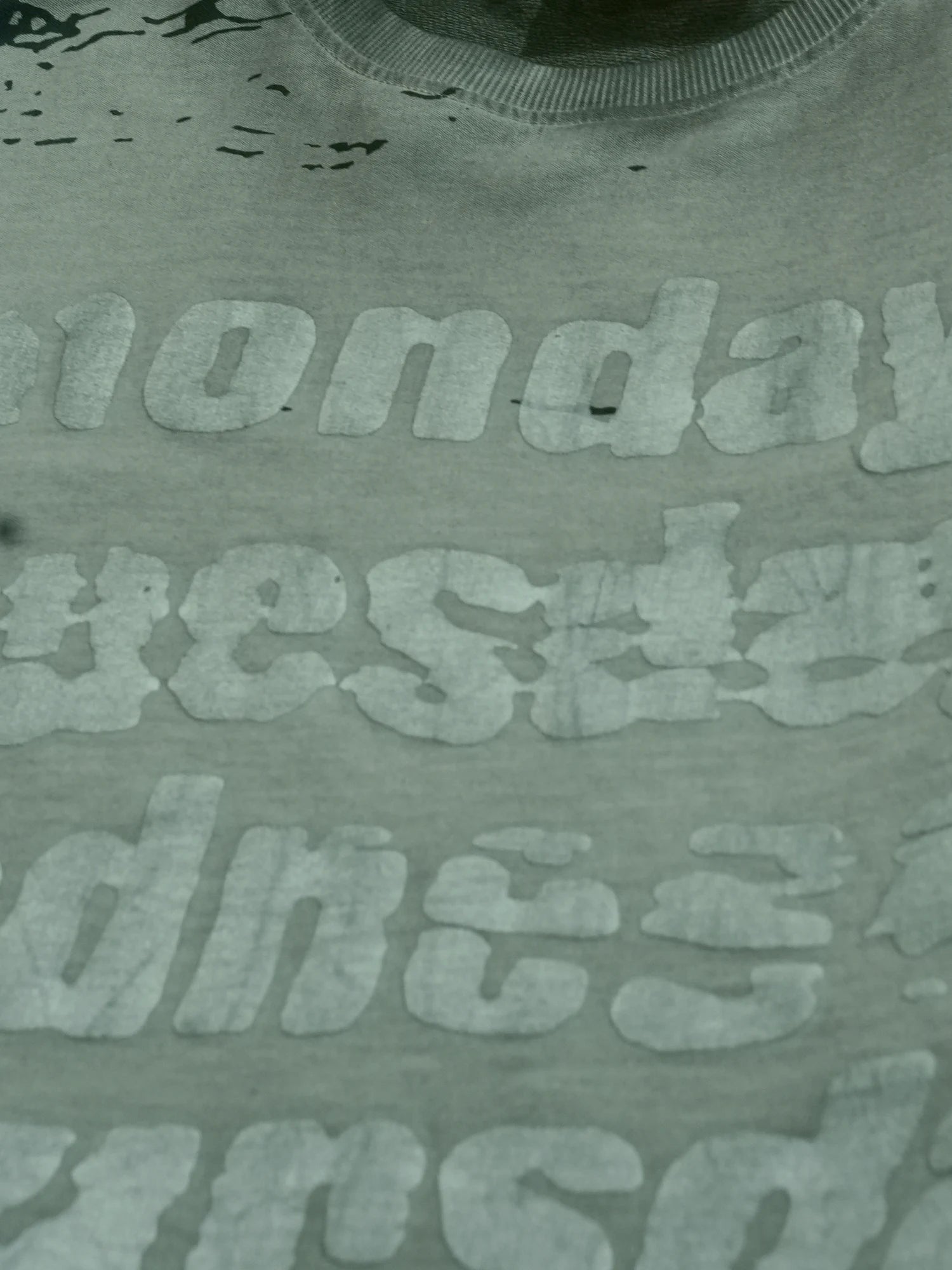 Casual grey oversized printed T-shirt for men paired with light blue jeans and sneakers for holiday outings