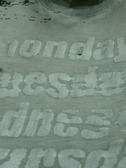 Casual grey oversized printed T-shirt for men paired with light blue jeans and sneakers for holiday outings